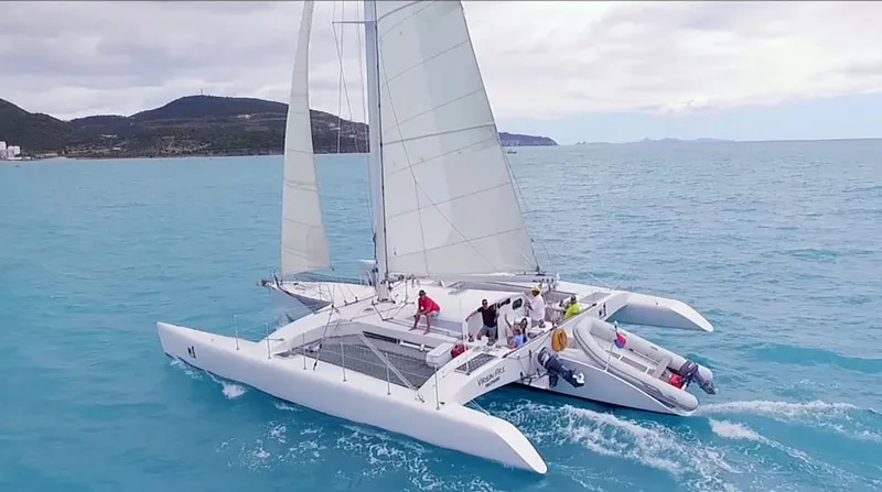 Trimaran sailing into the sunset on a Sint Maarten island tour evening cruise off the west coast of Sint Maarten