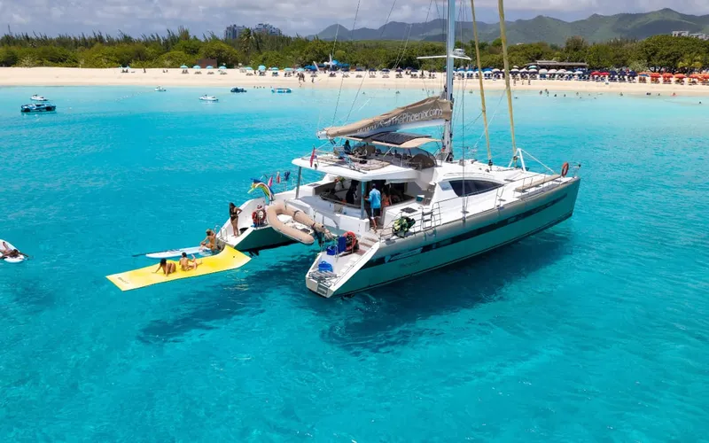 Guests relaxing on a luxury catamaran deck on a Sint Maarten island tour day sail in Sint Maarten
