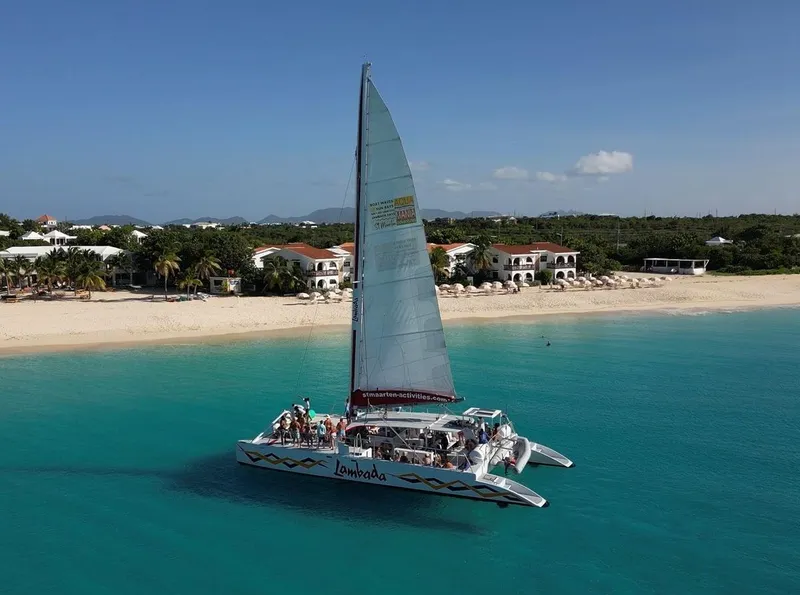 White catamaran sailing toward Anguilla on a full-day Sint Maarten island tour cruise from Sint Maarten