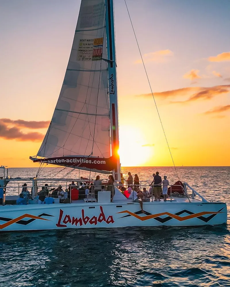 Catamaran sailing past the coastline at sunset on a Simpson Bay Sint Maarten island tour cruise in Sint Maarten