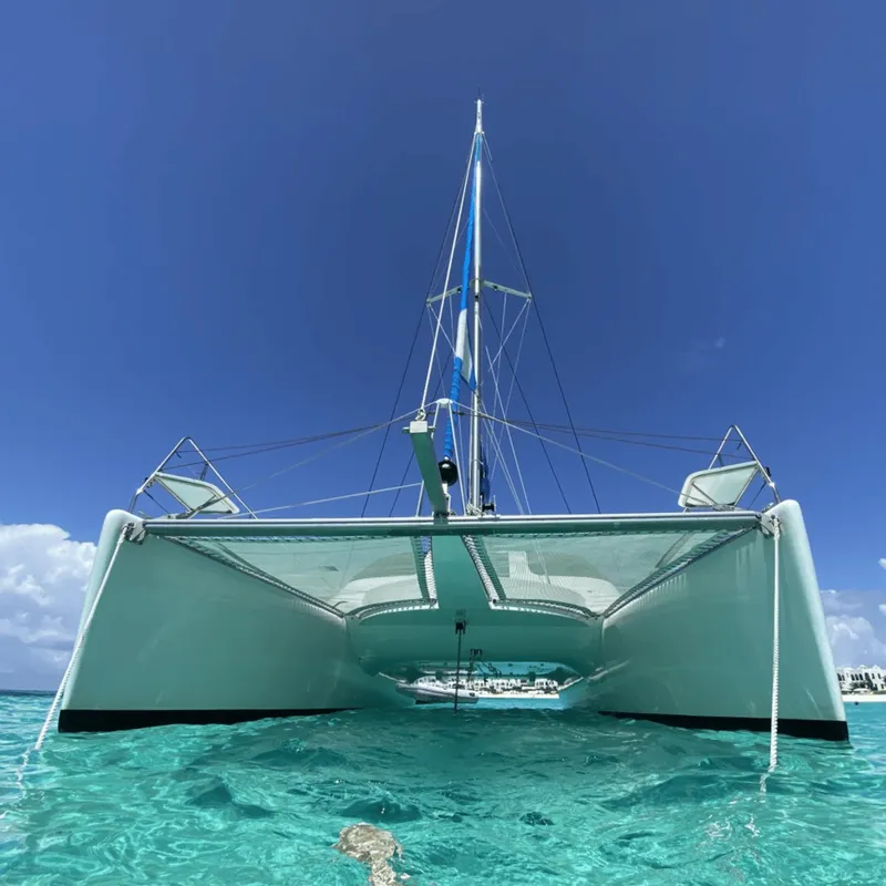 Travelers snorkeling beside a catamaran on a St Martin Sint Maarten island tour cruise with open bar in Sint Maarten